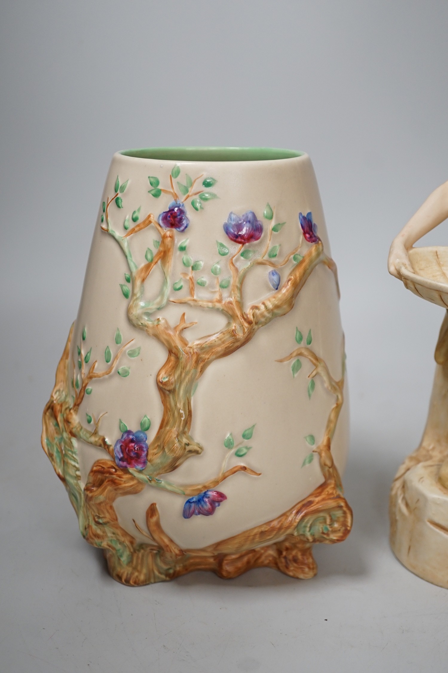 A Royal Dux figure of a water carrier and a Clarice Cliff for Newport Pottery vase. Tallest 27cm